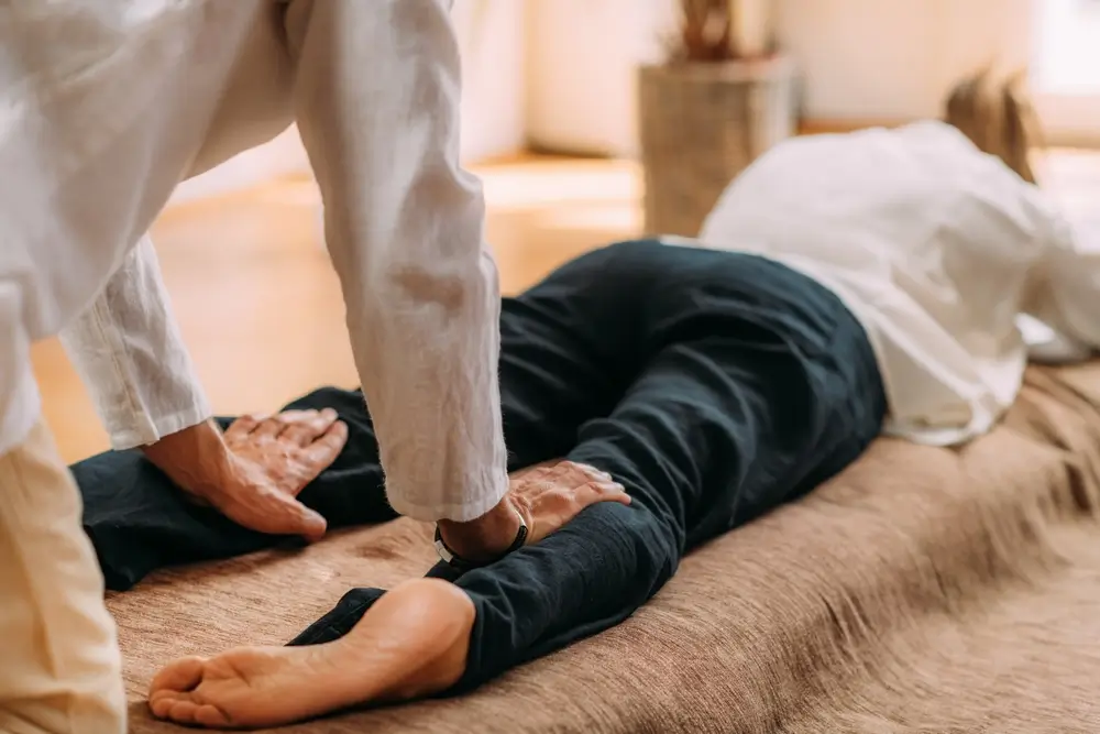 Thérapiste massant les jambes de la femme.